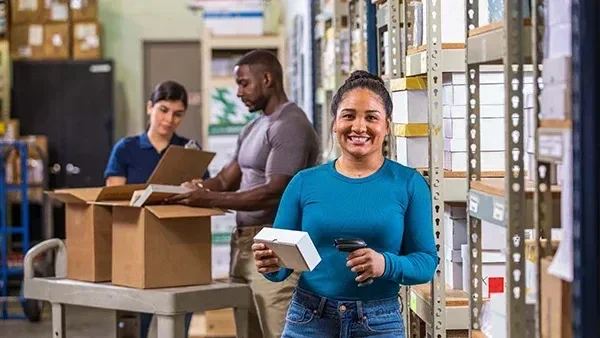 Warehouse workers preparing packages for shipment